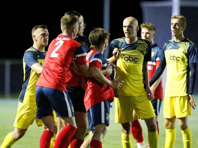 Harry Birmingham (middle of the three Moneyfields players in yellow) is available again after suspension for this weekend's Wessex League trip to Pagham. Picture by Dave Bodymore.