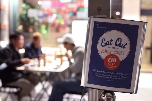 People eating on tables placed outside a restautant in Chinatown in Soho, London, as the government initiative Eat Out to Help Out comes to an end. PA Photo. Picture date: Monday August 31, 2020. Photo credit should read: Yui Mok/PA Wire