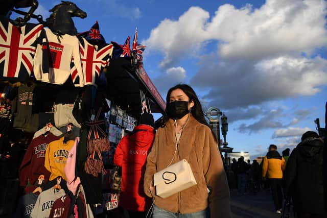 A pedestrian wears a face mask as they cross Westminster Bridge in central London. Picture: DANIEL LEAL-OLIVAS/AFP via Getty Images