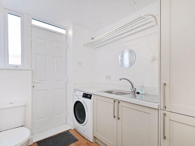 From the kitchen, a door opens into the utility room/downstairs WC with matching units, a cupboard which houses the combination boiler, a sink and a pulley maid for clothes drying. There is space and plumbing for a washing machine and a door which opens into the garden at the rear.