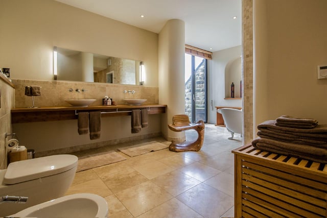 There are four modern bathrooms, with this family room comprising a Heritage claw footed bathtub, dual feature sink units, walk-in spa shower and a glass door which opens to a sauna.