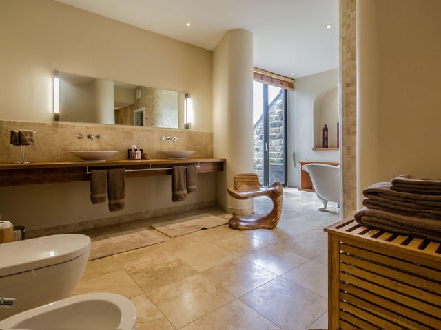 There are four modern bathrooms, with this family room comprising a Heritage claw footed bathtub, dual feature sink units, walk-in spa shower and a glass door which opens to a sauna.