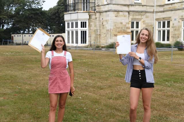 Left, Lottie Fisher, 18, who got a B in psychology, C in history and C in ancient history, with Chloe Davis, 18, who got A* in biology, A in maths and A in chemistry 
Picture: Paul Jacobs