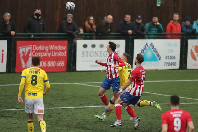 Dorking's Alfie Rutherford (centre) heads the first of his three goals. Picture: Dave Haines