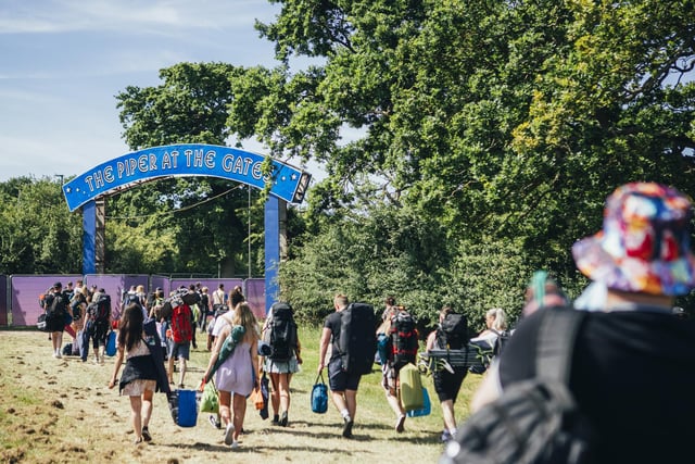 New arrivals walking under a tribute to Pink Floyd at Isle of Wight Festival 2022.