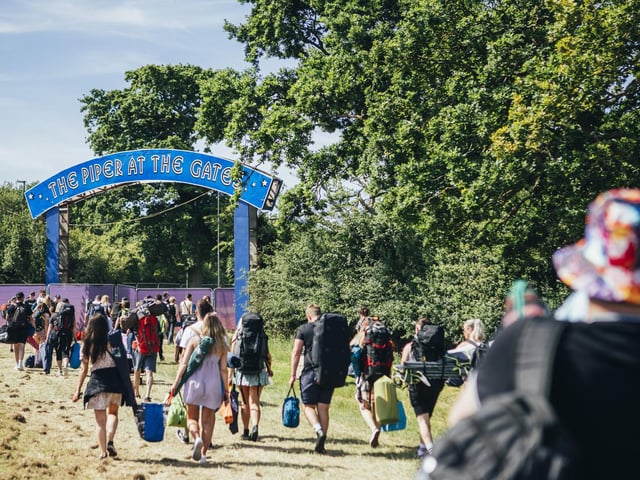 New arrivals walking under a tribute to Pink Floyd at Isle of Wight Festival 2022.