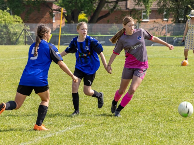 City Ladies (pink/grey kit) versus Clanfield Girls (blue) in the Clanfield youth football tournament at Horndean Technology College. Picture: Mike Cooter