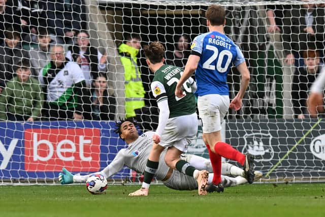 Josh Oluwayemi saves from Callum Wright during Pompey's 3-1 defeat at league leaders Plymouth. Picture Graham Hunt/ProSportsImages