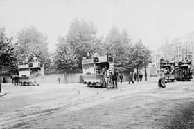 Horse trams of the Provincial Tramway Company with Museum Road going off to the left and Landport Terrace behind the female pedestrian
