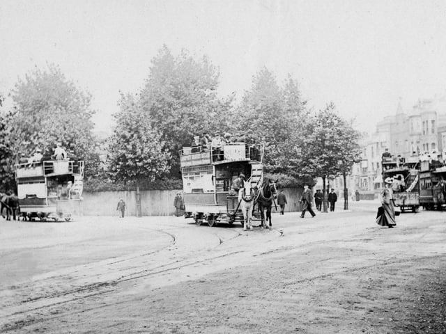 Horse trams of the Provincial Tramway Company with Museum Road going off to the left and Landport Terrace behind the female pedestrian