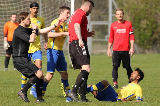 Neville Farley of Wymering is about to be shown a red card against Meon Milton. Pic: Kevin Shipp.