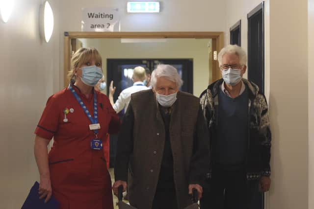 Pictured: Michael Tibbs, 99, his son Philip Tibbs and Liz Rix, Chief Nurse this morning after Michael had his vaccine jab.Michael Tibbs is the first person in the South West to receive the Covid-19 vaccination at Queen Alexandra Hospital in Portsmouth, Hants by Chief Nurse Liz Rix.© Ewan Galvin/Solent News & Photo AgencyUK +44 (0) 2380 458800