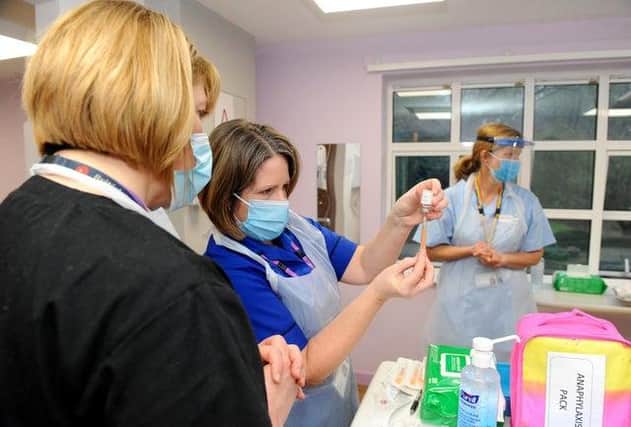 The Portsmouth NHS Covid-19 Vaccination Centre at Hamble House based at St James Hospital opened on Monday, February 1. Pictured is: (middle) Nurse Teresa Ellis prepares the vaccination. Picture: Sarah Standing (010221-2014)