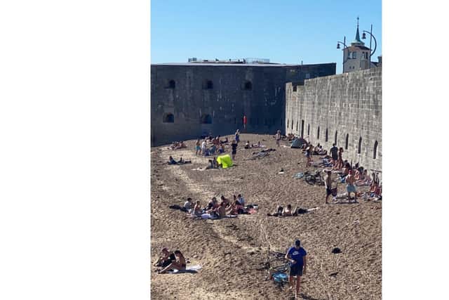 People gathered in large groups by the Hot Walls in Old Portsmouth yesterday. Picture: Rob Watkins