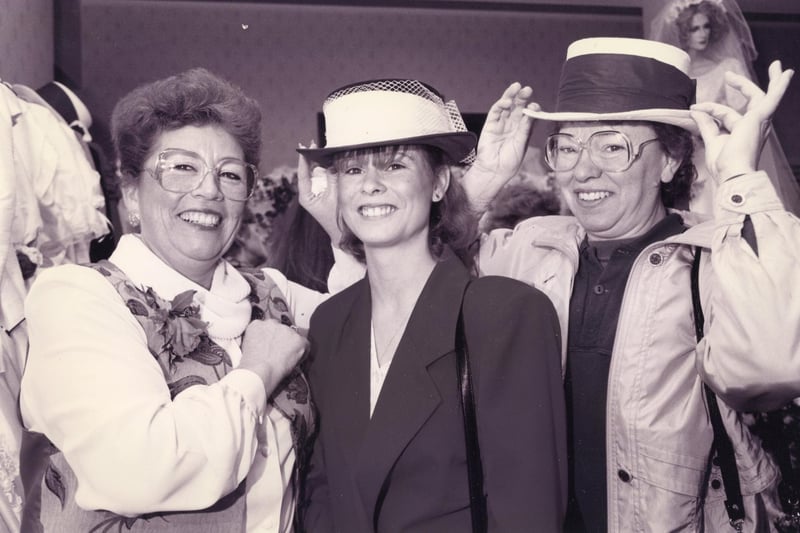 Maureen Vaughan of Bridal Dreams (left) assisting Jacqueline Hallett (23) and her mum Teresa Hellett (45) with a hat for their big day during their visit to The News' Fareham wedding show at the Solent Hotel, Whiteley. In 1995. The News PP1947