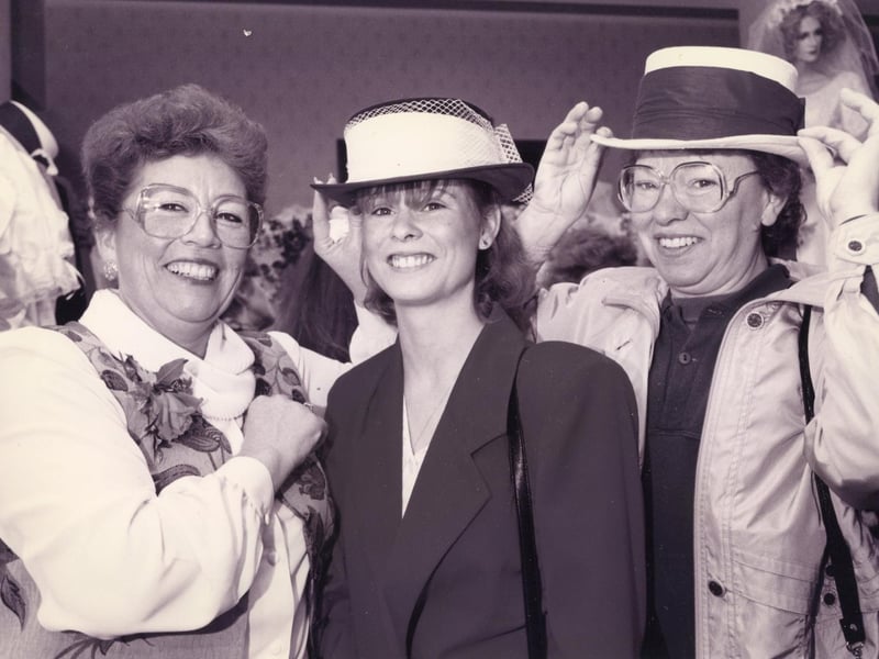 Maureen Vaughan of Bridal Dreams (left) assisting Jacqueline Hallett (23) and her mum Teresa Hellett (45) with a hat for their big day during their visit to The News' Fareham wedding show at the Solent Hotel, Whiteley. In 1995. The News PP1947