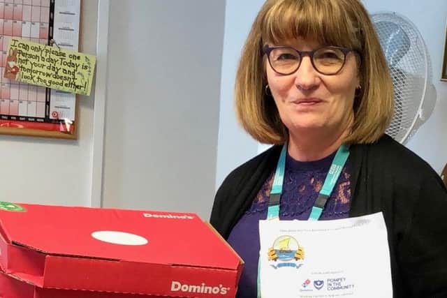 Karen Ponting at Gosport War Memorial Hospital accepts some pizzas for key worker staff donated by Dominio's and delivered by volunteers at Gosport Borough FC. Picture by Keith Slater