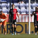 Sean Raggett and Joe Morrell look dejected after Callum Lang's 78th-minute winner at the DW Stadium.  Picture: Daniel Chesterton/phcimages.com)