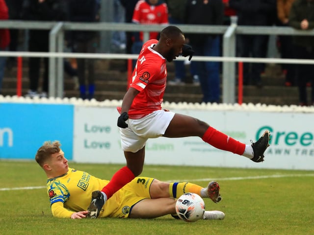Joe Newton makes a sliding tackle. Picture by Dave Haines
