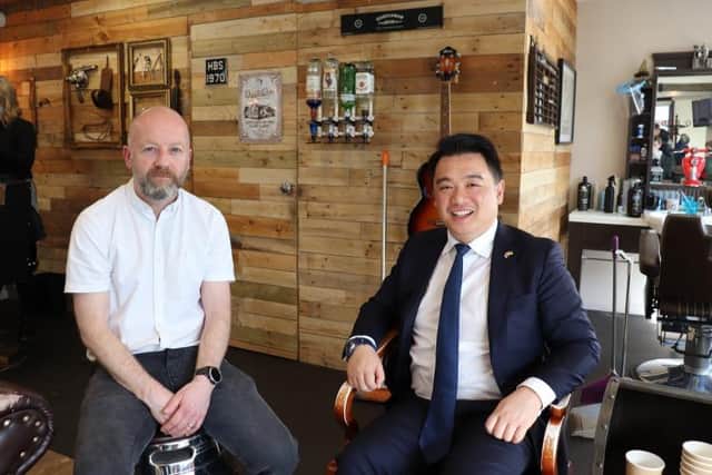 Mark Griffiths, owner of Hayling Barber Shop, and Alan Mak, MP for Gosport.