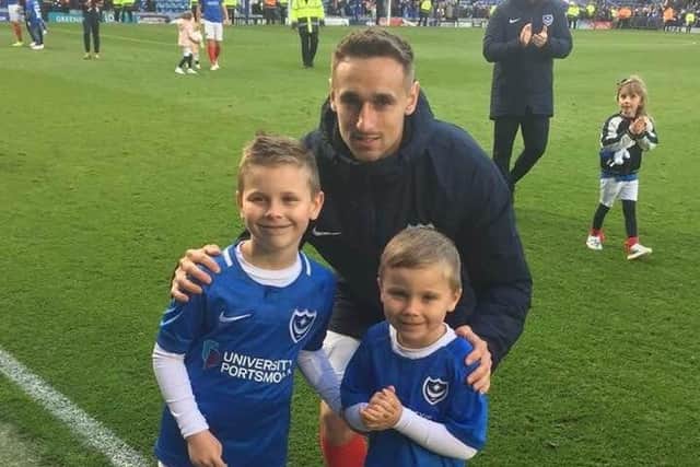 Big brother and former Pompey player Brandon Haunstrup, centre, with younger siblings Ethan, left, and Isaac pitchside at Fratton Park