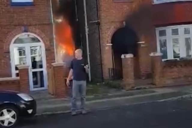 Daniel Wakelin, 44, pictured retreating from the blazing home after valiantly attempting to break in and rescue a 101-year-old woman who was trapped inside.