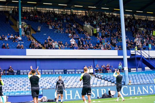 The Pompey players clap the travelling fans as they begin their warm-ups.