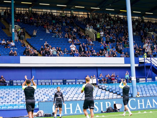 The Pompey players clap the travelling fans as they begin their warm-ups.