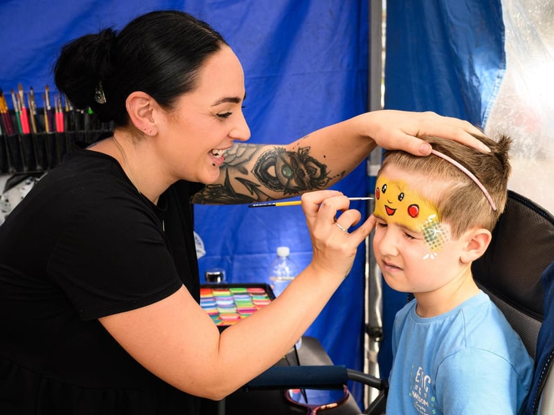 Pictured is: Cheri Hopson paints a face on Rees Wilton.
Picture: Keith Woodland (100921-10)