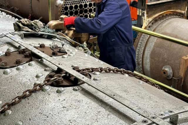 Volunteer Brian Carter works on the Canadian Pacific’s boiler