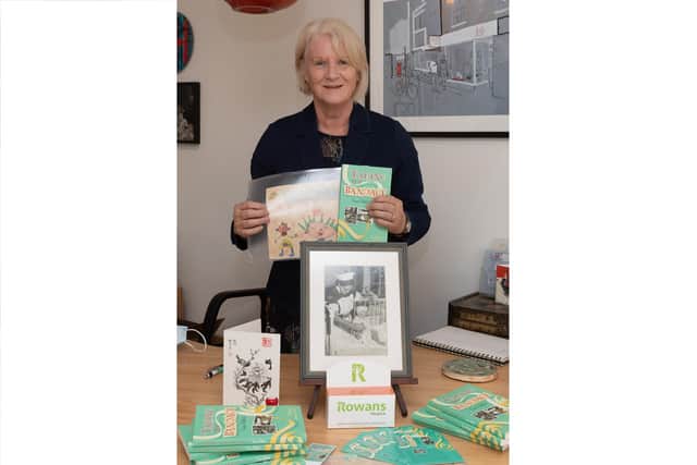 Fiona Ballard with her book Taking the Bandage, childhood drawings and photograph of her in hospital as a baby 
Picture: Keith Woodland (301021-2)