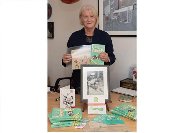Fiona Ballard with her book Taking the Bandage, childhood drawings and photograph of her in hospital as a baby
Picture: Keith Woodland (301021-2)