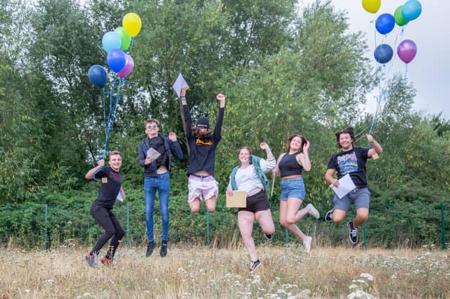 Students celebrate by jumping in the air at Portsmouth College.
Picture: Habibur Rahman
