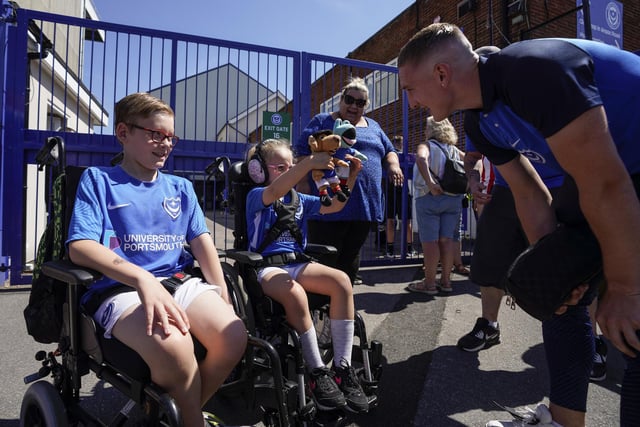 Pompey forward Ronan Curtis has a word with two young Pompey fans before kick off.