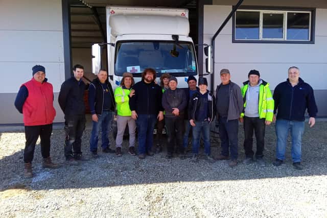 Ryan Fuller with the truck and some of the volunteers in Romania