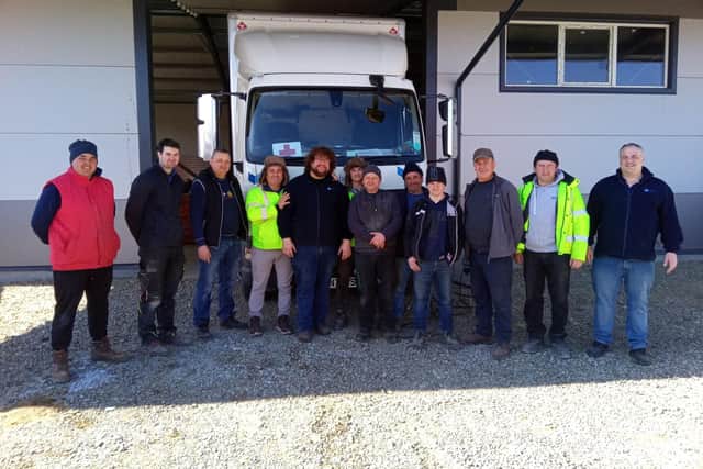 Ryan  Fuller with the truck and some of the volunteers in Romania
