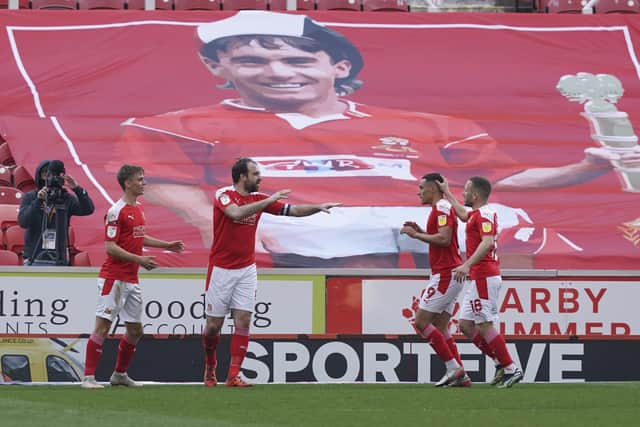 Former Pompey striker Brett Pitman celebrates in front of Swindon's flag of former Blues midfielder Alan McLoughlin