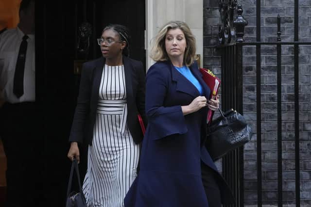 Britain's Leader of the House of Commons Penny Mordaunt, right, and Secretary of State for International Trade Kemi Badenoch leave after a cabinet meeting at 10 Downing Street in London, Tuesday, Oct. 18, 2022. (AP Photo/Kin Cheung)