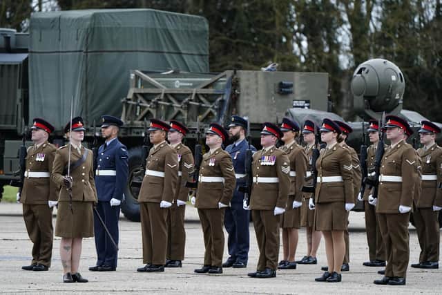 Soldiers from the 16 Regiment Royal Artillery on parade as they take part in the change of colours parade as the regiment bids farewell to its Rapier missiles, pictured rear, and welcomes in the all new state-of-the-art Sky Sabre air defence system as its ceremonial colours, at Baker Barracks on Thorney Island. Picture date: Thursday January 27, 2022.