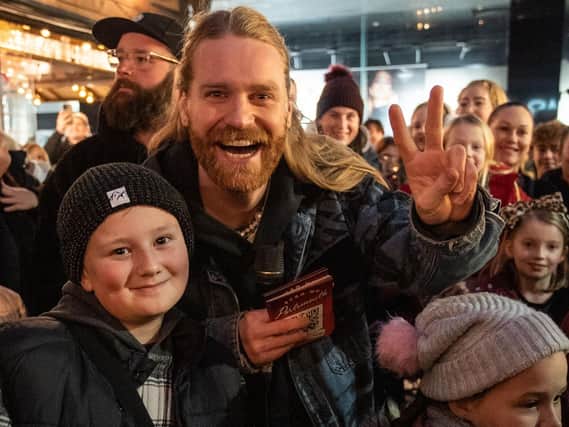 Sam Ryder poses for pictures with fans in Commercial Road, Portsmouth as he bids to become Christmas number one.