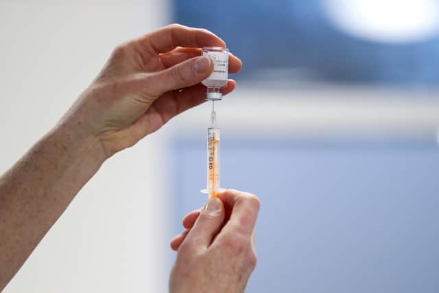 A healthcare worker fills a syringe with a dose of the Oxford/AstraZeneca coronavirus vaccine at Pentlands Medical Centre in Edinburgh, Scotland, as the government continues to ramp up the vaccination programme against Covid-19. Photo: PA