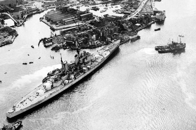 HMS Vanguard runs aground in Portsmouth Harbour after breaking loose but narrowly avoids the Still & West pub,  August 4, 1960. The News PP5335