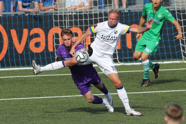 Hawks striker Scott Rendell tries to block Oxford City keeper Ben Dudzinski from gaining possession. Picture by Dave Haines.