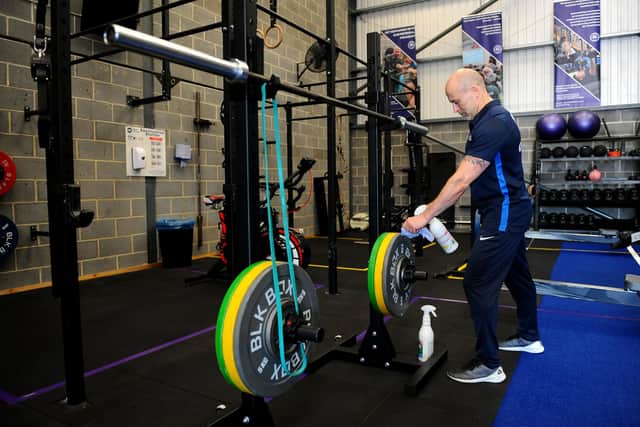 Ex-Navy PTI Sean Cole from SC Vital Fitness in Portsmouth, cleaning his indoor gym equipment which has been spaced out to allow for social distancing. 

Picture: Sarah Standing (230620-334)