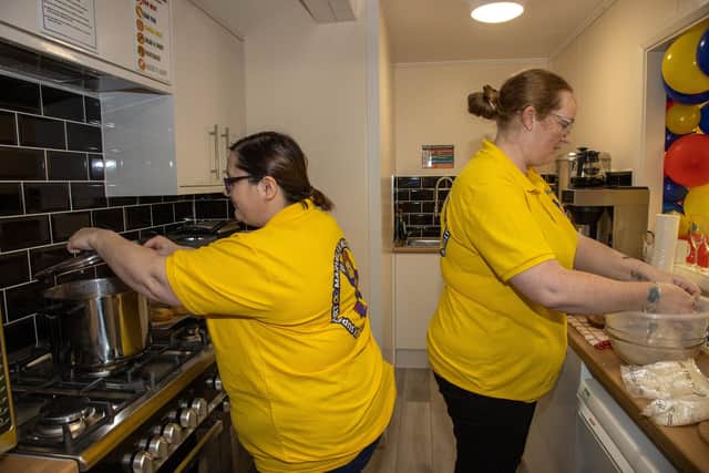 Volunteers Layla Churcher and Ria Watch prepare food for their visitors in the newly fitted kitchen within Marvels and Meltdowns which celebrated their opening on Monday morning in Gosport. Photos by Alex Shute