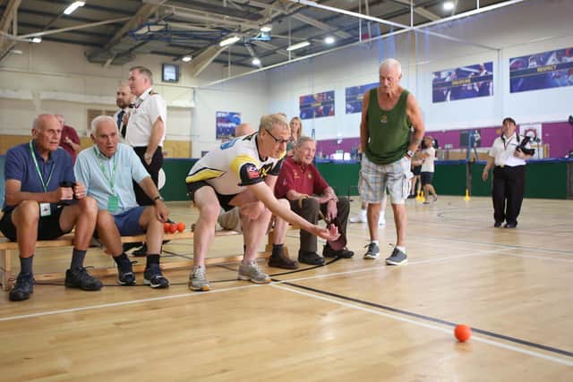Veteran, Charlie Eastwood having a go on indoor bowls