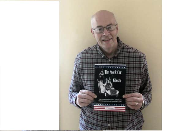 Steve Daily holding a copy of The Stock Car Ghosts