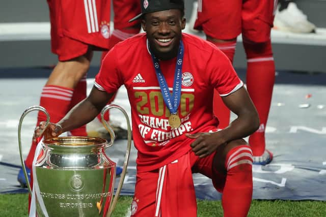 Bayern Munich's Canadian midfielder Alphonso Davies celebrates with the Champions League trophy (Photo by Miguel A. Lopes / POOL / AFP) (Photo by MIGUEL A. LOPES/POOL/AFP via Getty Images)