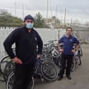 GTR's Dylan Lohman (left) delivers 25 abandoned bikes to Paul Horta-Hopkins at SCDA's recycling workshop