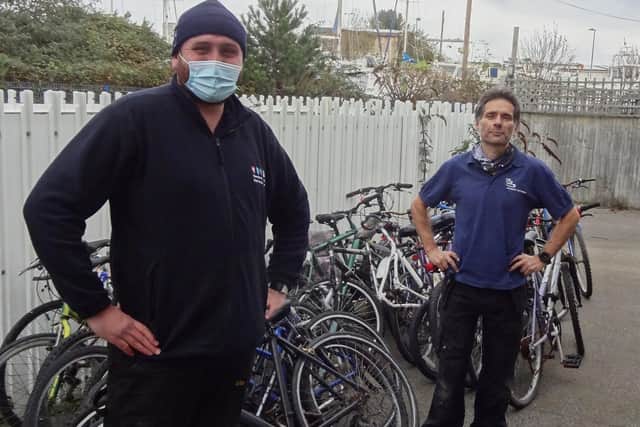 GTR's Dylan Lohman (left) delivers 25 abandoned bikes to Paul Horta-Hopkins at SCDA's recycling workshop